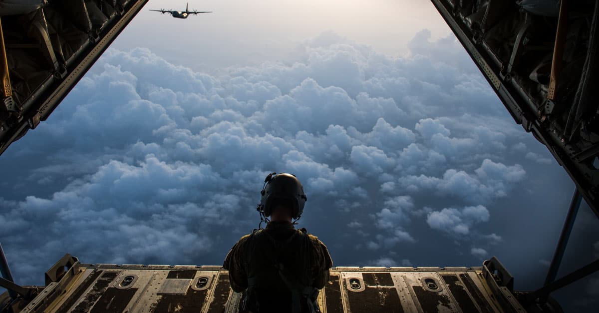 C-130_A U.S. Airman with the 75th Expeditionary Airlift Squadron sits on the ramp of a C-130J Super Hercules