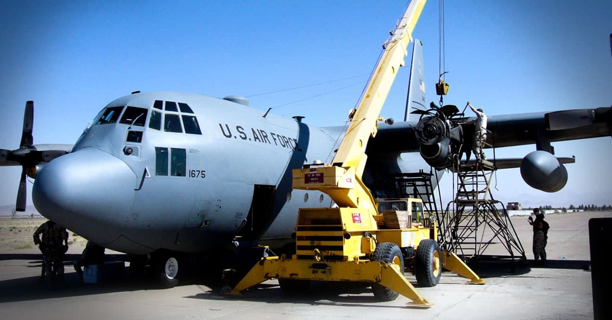 C-130_Maintenance repair teams frchange the engine of a C-130 Hercules under harsh conditions